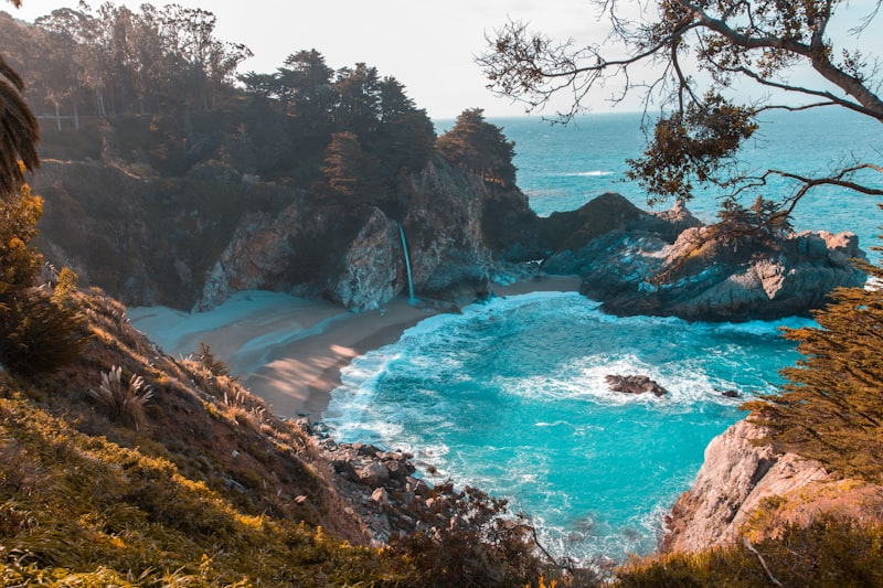 Coastal waterfall and beach featured in our travel packages